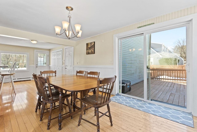 dining area with an inviting chandelier and light wood-style floors