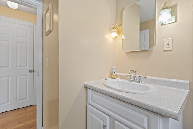 bathroom with vanity and wood finished floors