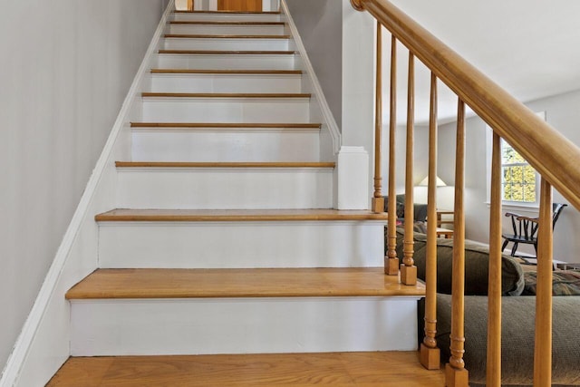 stairs featuring wood finished floors