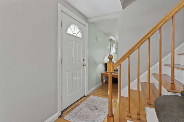 entrance foyer featuring stairs, wood finished floors, and baseboards