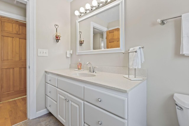 bathroom with tile patterned floors, toilet, and vanity