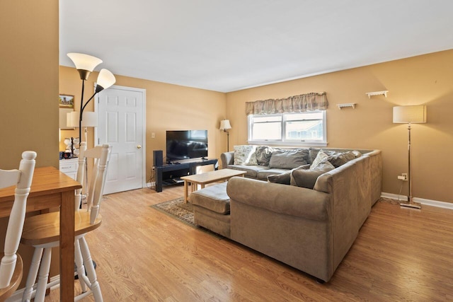 living room featuring light wood-style flooring and baseboards