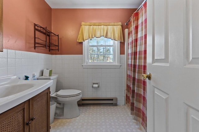 full bath featuring baseboard heating, wainscoting, toilet, and vanity