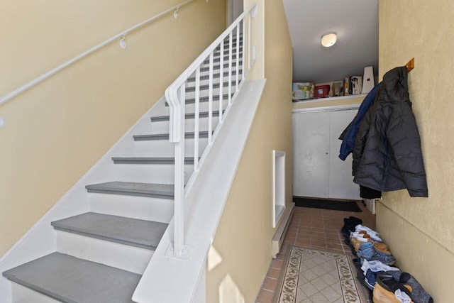 stairway with tile patterned flooring