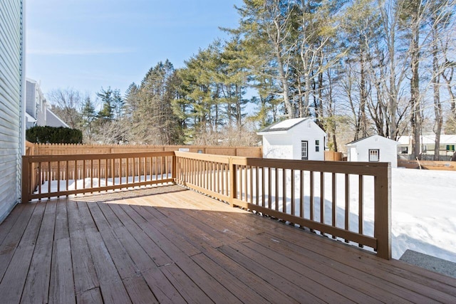 deck featuring an outbuilding and fence