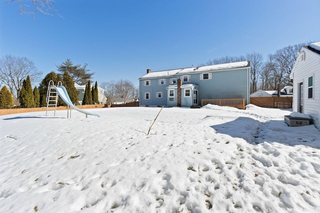 snow covered property featuring fence