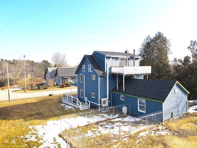 exterior space with ac unit, a chimney, and fence