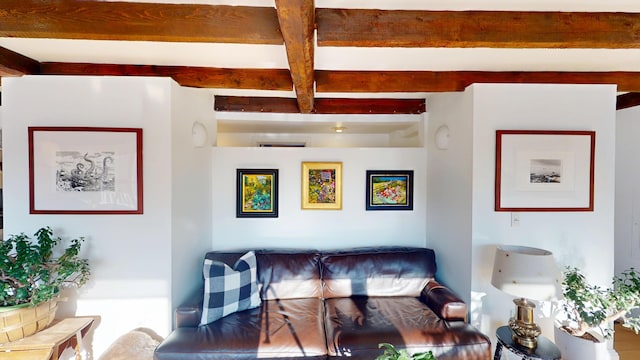 living area featuring beamed ceiling