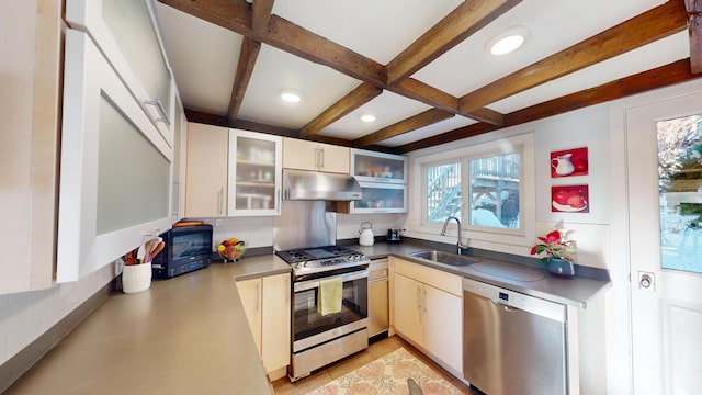 kitchen with stainless steel appliances, beamed ceiling, a sink, and under cabinet range hood