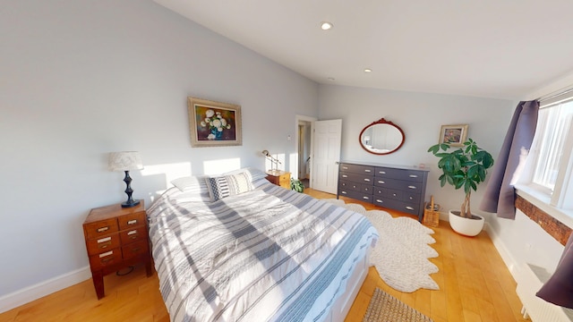 bedroom with lofted ceiling, recessed lighting, baseboards, and wood finished floors