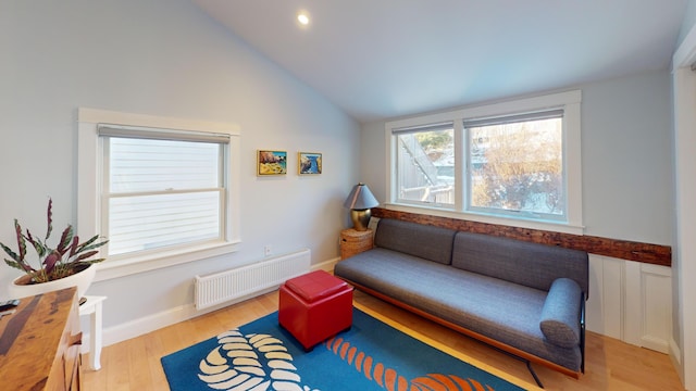 sitting room featuring recessed lighting, baseboards, vaulted ceiling, light wood-type flooring, and radiator