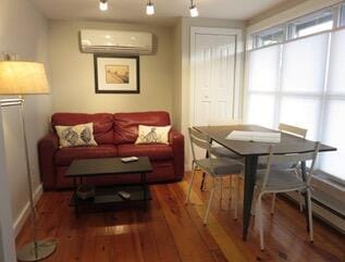 interior space featuring hardwood / wood-style flooring and a wall mounted AC