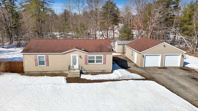 view of front of home with fence, a garage, and roof with shingles