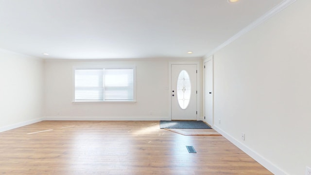 entrance foyer featuring visible vents, crown molding, baseboards, light wood-type flooring, and recessed lighting