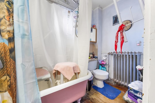 bathroom with toilet, radiator heating unit, and wood finished floors