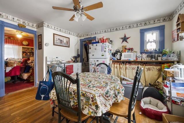 dining room with a ceiling fan and wood finished floors