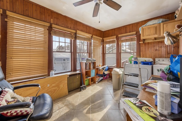 interior space featuring a ceiling fan, a wealth of natural light, and independent washer and dryer