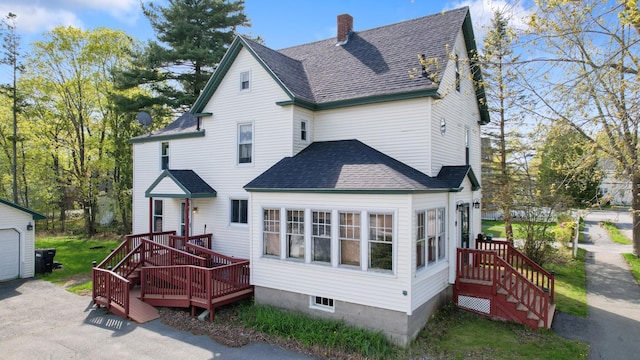 70 Savage St, Bangor, ME 04401 - back of house with a chimney, a shingled roof, and an outbuilding