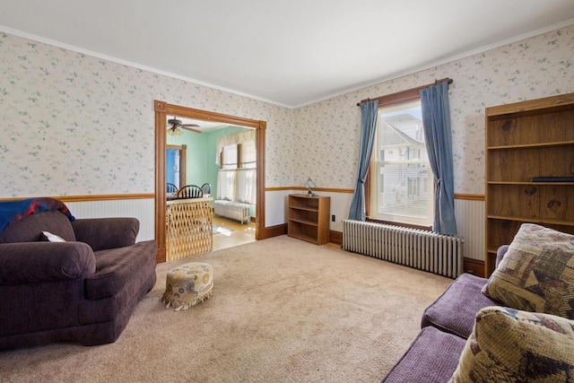 70 Savage St, Bangor, ME 04401 - living area with radiator heating unit, wainscoting, wallpapered walls, crown molding, and carpet floors