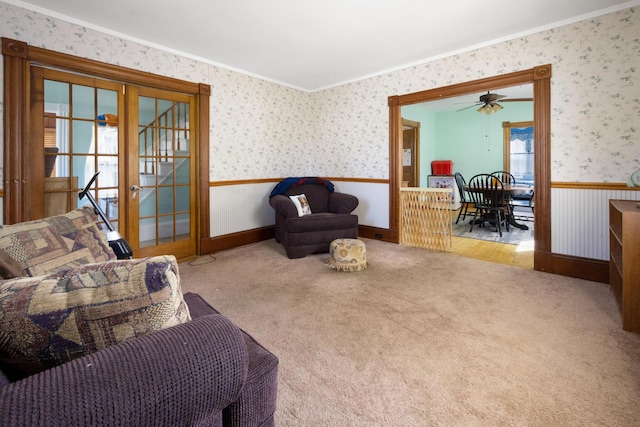 70 Savage St, Bangor, ME 04401 - living area featuring a wainscoted wall, wallpapered walls, carpet flooring, crown molding, and a ceiling fan