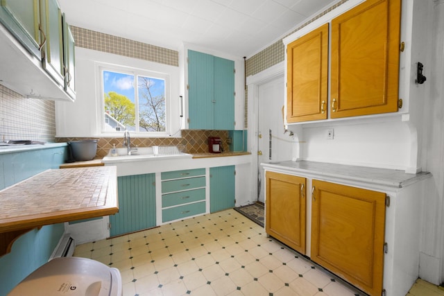 70 Savage St, Bangor, ME 04401 - kitchen featuring light flooring, light countertops, tasteful backsplash, and a sink