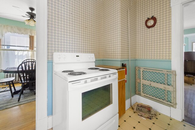 70 Savage St, Bangor, ME 04401 - kitchen with electric stove, wallpapered walls, and a ceiling fan
