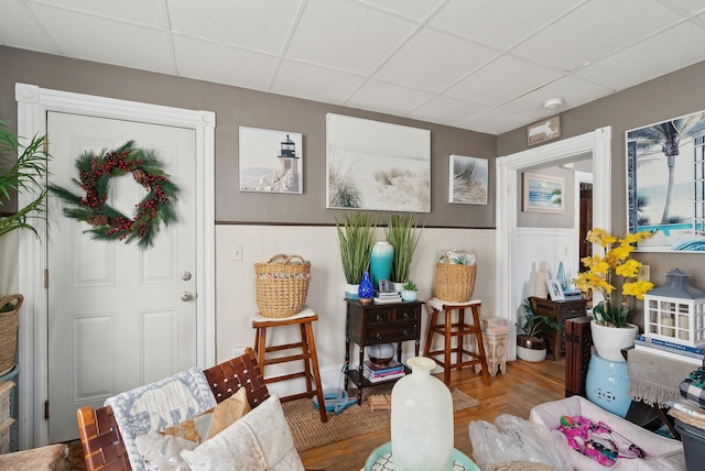 interior space with wood finished floors and a paneled ceiling