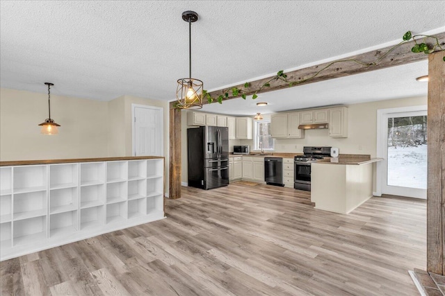 kitchen featuring a textured ceiling, stainless steel appliances, light wood-style floors, and under cabinet range hood