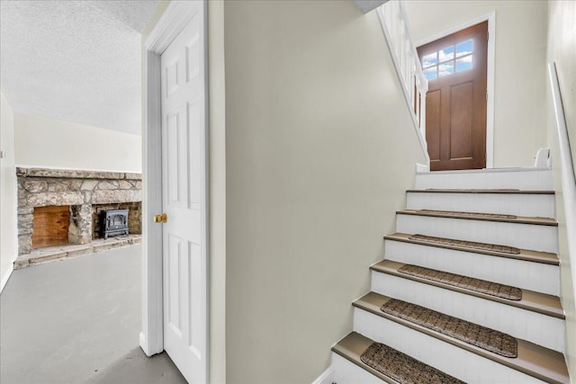 stairway with a textured ceiling