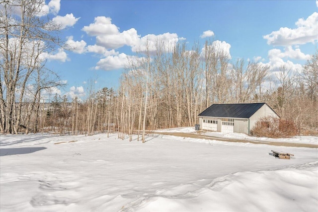 yard layered in snow featuring a garage