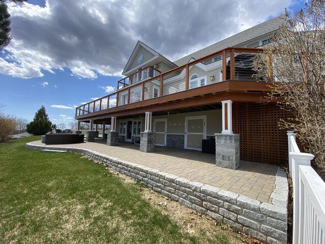 exterior space with a deck, a lawn, and a patio area