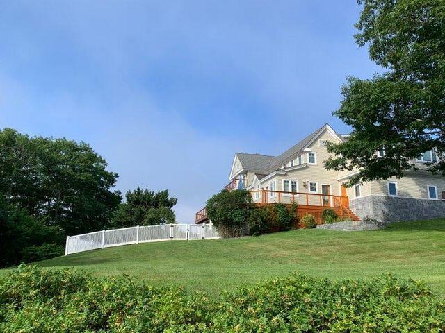 view of yard featuring fence and a wooden deck