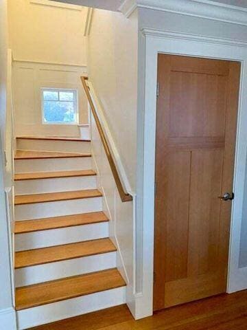 stairs featuring wood finished floors