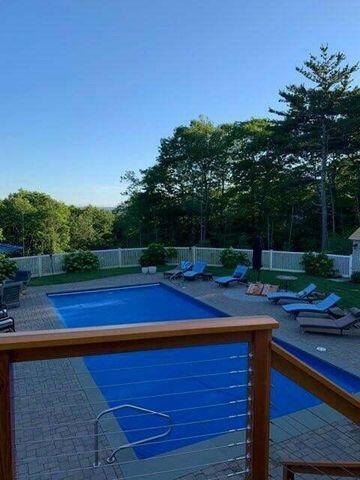 view of swimming pool featuring a patio, a fenced backyard, and a fenced in pool