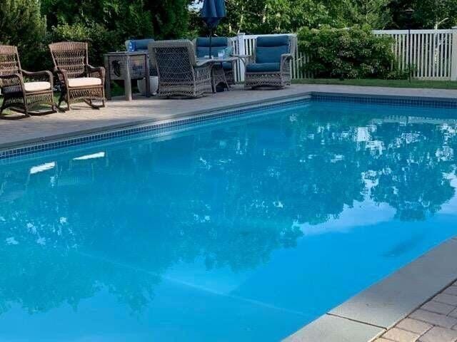 view of pool featuring a fenced in pool, fence, a patio, and an outdoor hangout area