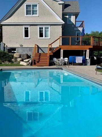 pool with stairs and a deck