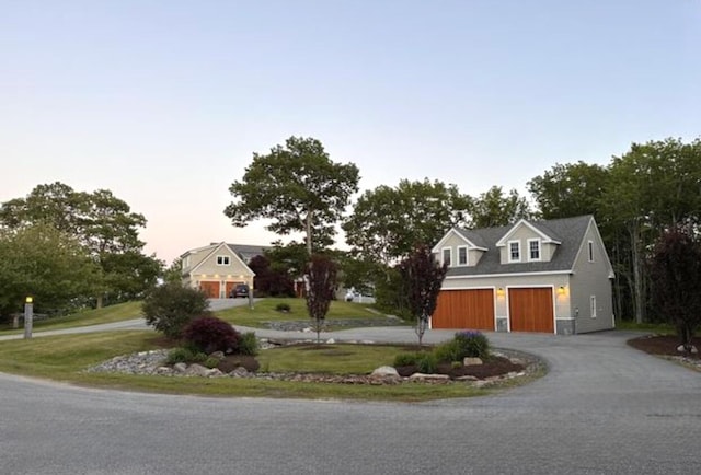 view of front of home featuring aphalt driveway and an attached garage