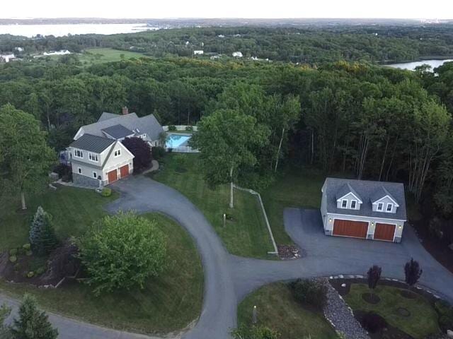 bird's eye view with a water view and a forest view