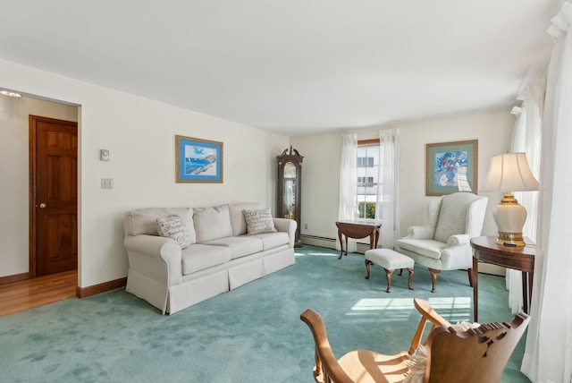 carpeted living room featuring a baseboard heating unit and baseboards