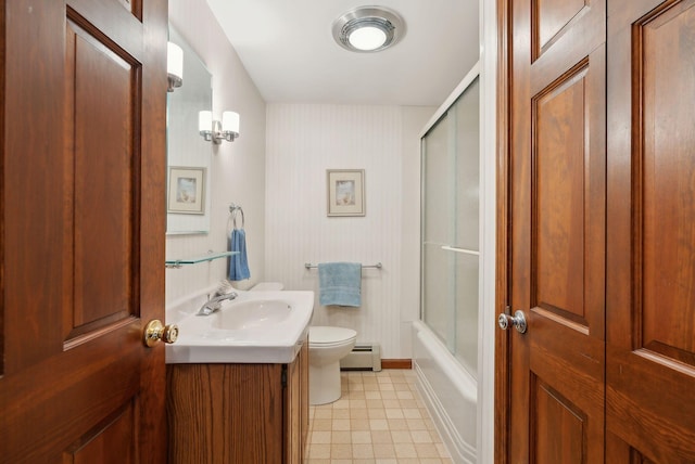 full bath with baseboards, toilet, shower / bath combination with glass door, vanity, and a baseboard radiator