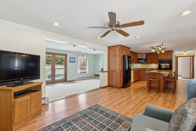 living area featuring recessed lighting, light wood-type flooring, a baseboard heating unit, and ceiling fan