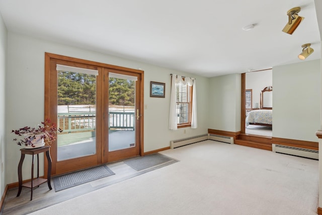 entryway featuring carpet floors, baseboards, and a baseboard radiator