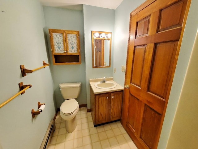 half bathroom featuring toilet, baseboard heating, vanity, and baseboards