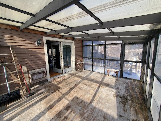 unfurnished sunroom with heating unit