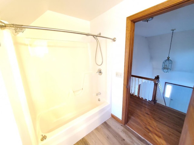 full bath with shower / bathing tub combination, baseboards, and wood finished floors