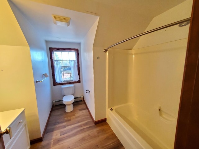 bathroom featuring toilet, wood finished floors, vanity, baseboards, and shower / bathing tub combination