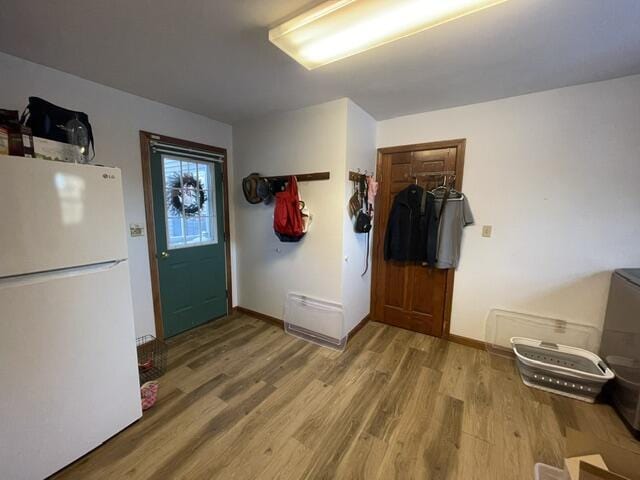 mudroom featuring wood finished floors and baseboards