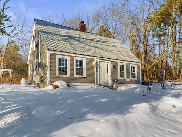 view of front of home featuring metal roof and a chimney