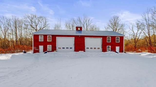 snow covered garage with a garage