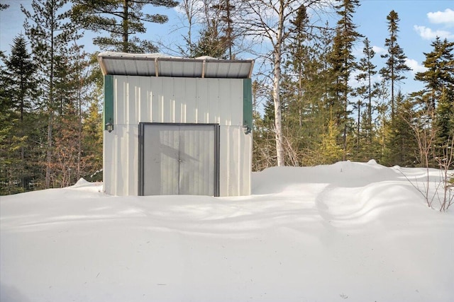 snow covered structure with an outdoor structure